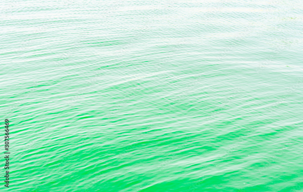 Bright green Tones Water Waves Surface as Background