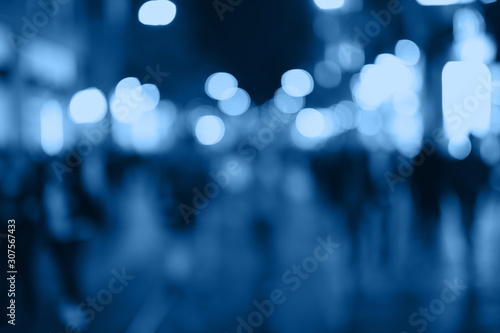 Blur people shopping in local street market with blue bokeh and sun light abstract background. Copy space of travel and business concept. Vintage tone filter color style.