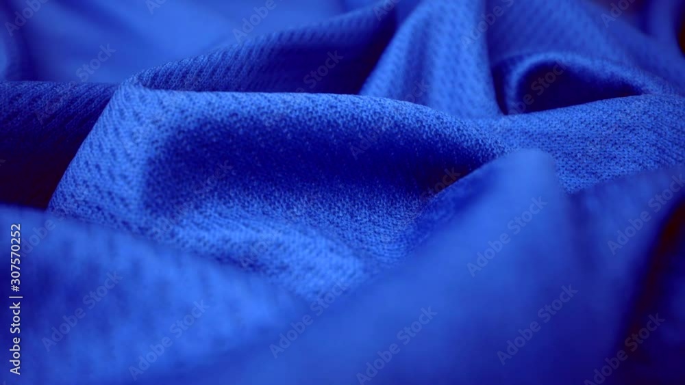 Close up detailed cloth texture of shiny spandex lycra cloth flowing with dolly shot in macro close-up view. Wavy clean elastic weave material. Textile abstract background. Clothing industry concept. Stock Video | Adobe Stock