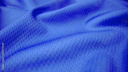 Close up detailed cloth texture of shiny spandex lycra cloth flowing with dolly shot in macro close-up view. Wavy clean elastic weave material. Textile abstract background. Clothing industry concept.