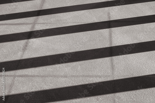 Abstract Black and White image of Light and shadow shading on concrete floor. (Selective focus)