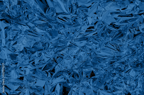 Abstract trendy classic blue colored crumpled foil texture background. 2020 color of the year trend concept.