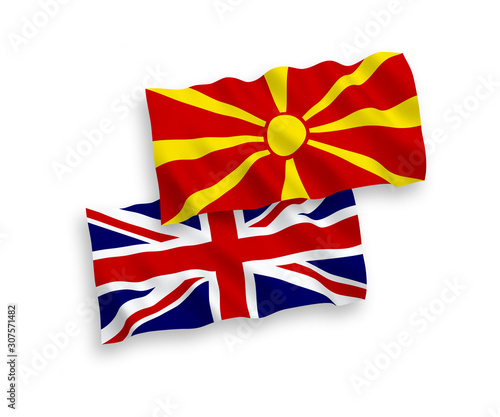 National vector fabric wave flags of Great Britain and North Macedonia isolated on white background. 1 to 2 proportion.