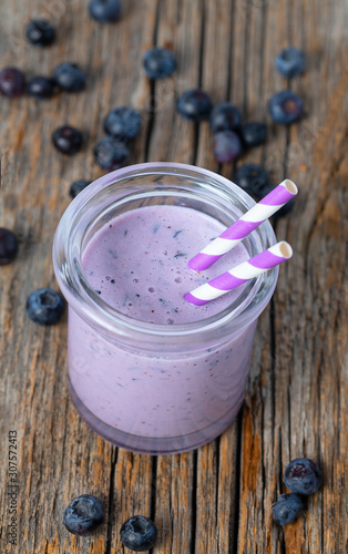 blueberry smoothie in a glass on wooden surface
