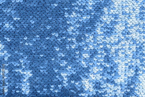 Blue shiny fabric with sequins, abstract background.