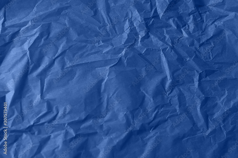 Obraz premium Textured crumpled paper in blue. Background for your design. Tinted paper.