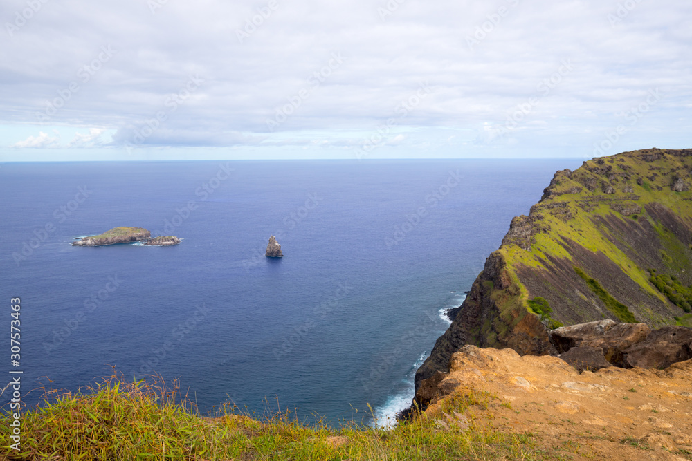 View of the slopes of the crater of Rano Kau in Easter Island with rock islets of Motu Kao Kao, Motu Iti and Motu Nui. Easter Island, Chile