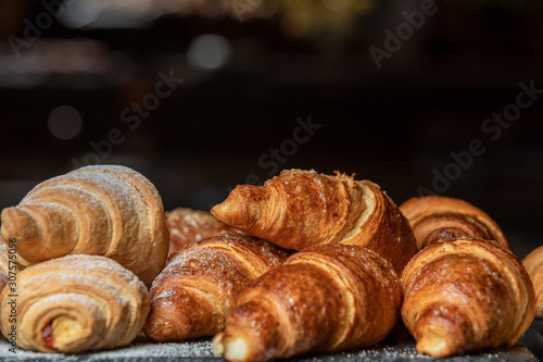 Fresh baked french croissants in a bakery, close up.
