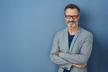 Friendly confident professional man on blue