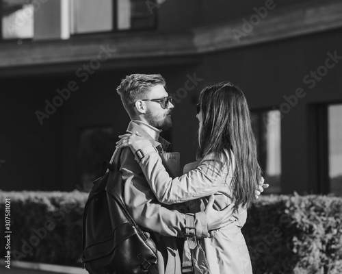 black and white portrait of a young couple in the city. tourism