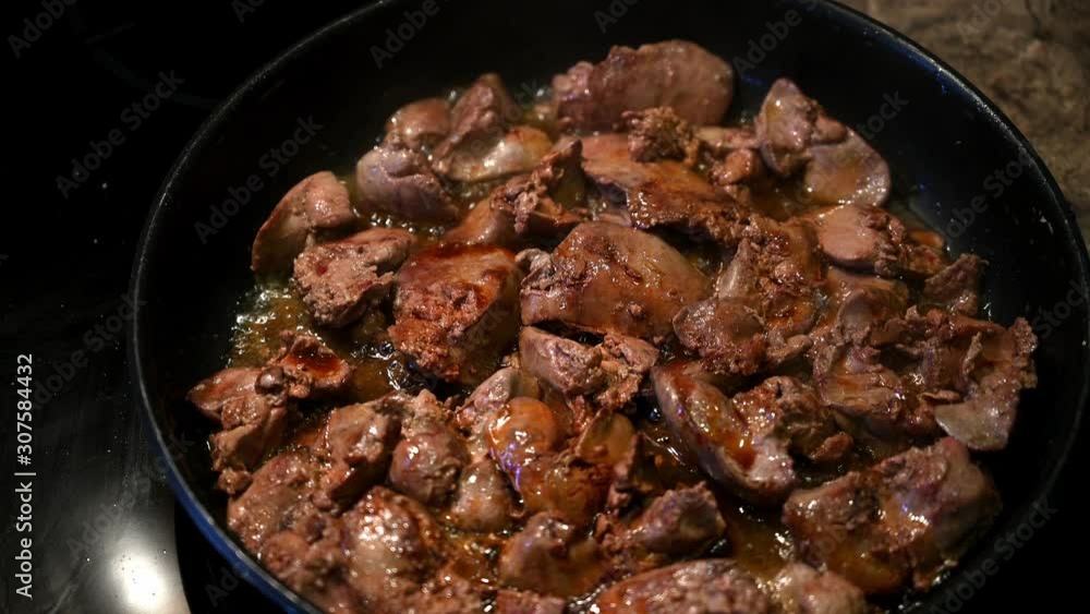 Homemade chicken liver is fried in a frying pan and watered with soy sauce Homemade chicken liver is fried in a frying pan and watered with soy sauce