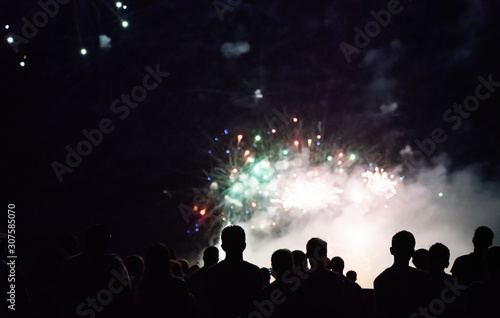 Crowd watching fireworks and celebrating new year eve