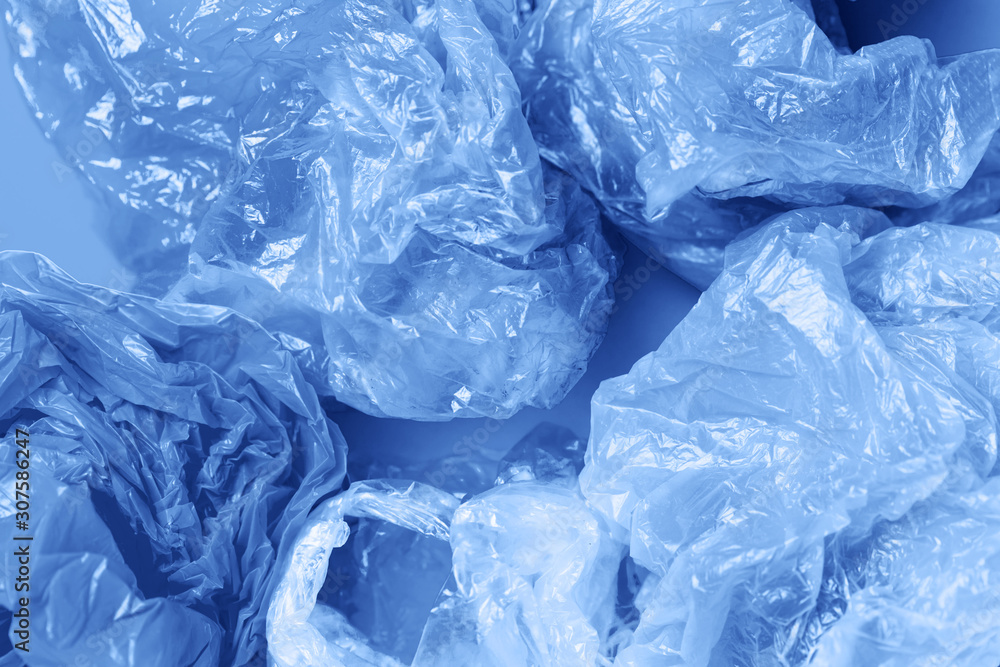 Save the planet concept: plastic trash, plastic bags and garbage. Environment pollution concept. Classic blue color of 2020.. Flat lay. top view Save the planet concept: plastic trash, plastic bags and garbage. Environment pollution concept. Classic blue color of 2020.. Flat lay. top view