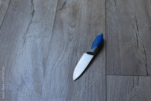 the knife lies on the floor. close-up. domestic violence concept.