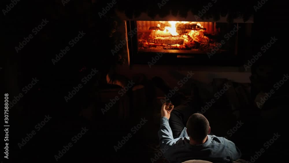 A man drinks brandy by the fireplace. Top view A man drinks brandy by the fireplace. Top view