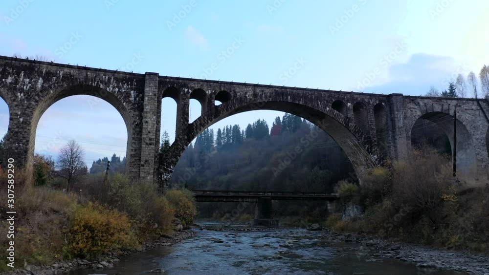 Old viaduct bridge. Railway bridge trough the river. Ukrainian Carpathian. Old viaduct bridge. Railway bridge trough the river. Ukrainian Carpathian.