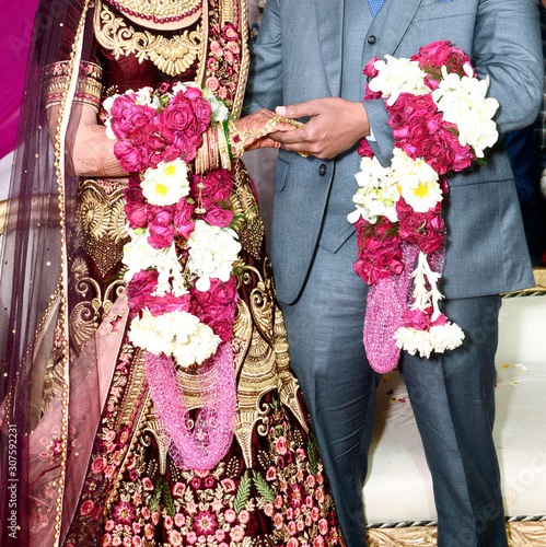 The bride and groom at the Indian wedding garlands or Jaimala ceremony photo