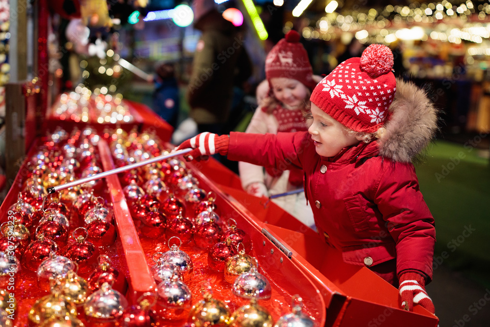 Kids at Christmas fair. Children shopping xmas gifts. Kids at Christmas fair. Children shopping xmas gifts.