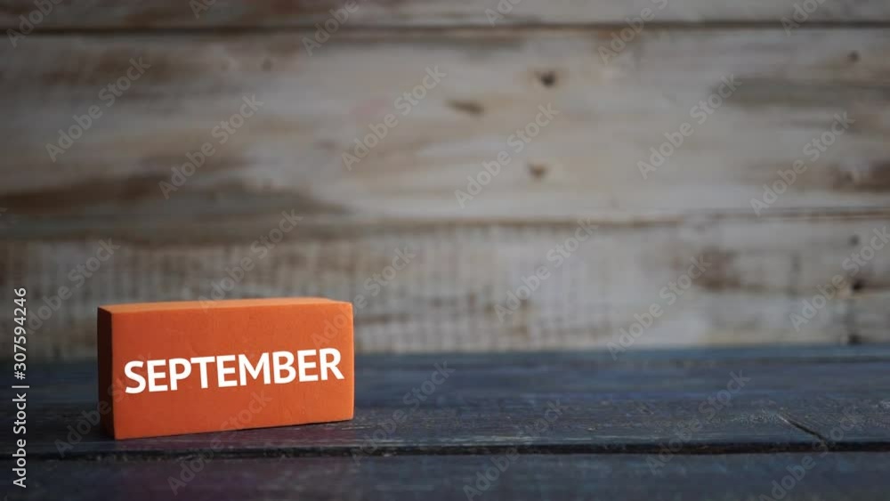 september 2nd. Day 2 of month, calendar on a color cubes. hand puts the day of the month on the name of the month on a wooden background autumn, day of the year concept september 2nd. Day 2 of month, calendar on a color cubes. hand puts the day of the month on the name of the month on a wooden background autumn, day of the year concept