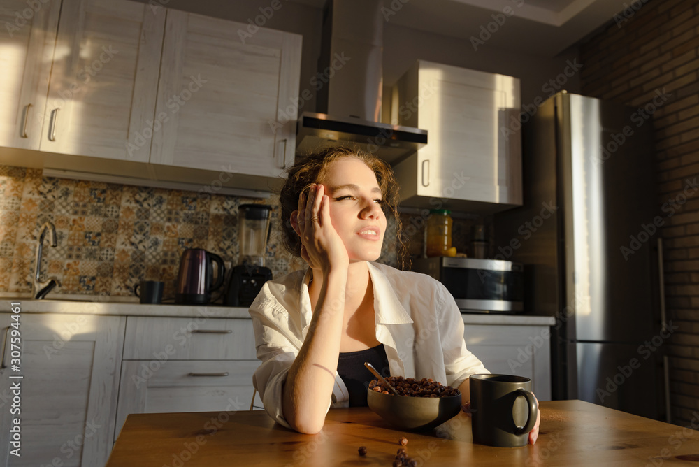 Young attractive girl eats breakfast in the kitchen Young attractive girl eats breakfast in the kitchen