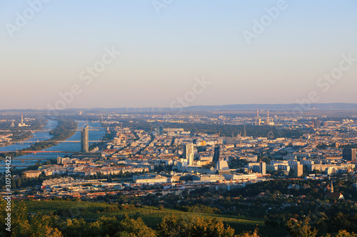 Vienna, Austria - 21 September 2019: Beautiful view of the evening skyline of Vienna and Danube River with green trees of Doebling district, Austria. Travel photo of the landmark