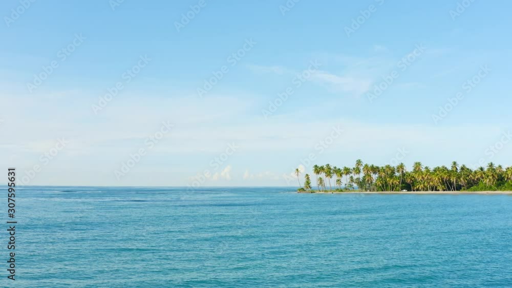 Sea and sky and palm trees island. Blu ocean and blue sky landscape. Tropical background. Nature palm island landscape Sea and sky and palm trees island. Blu ocean and blue sky landscape. Tropical background. Nature palm island landscape
