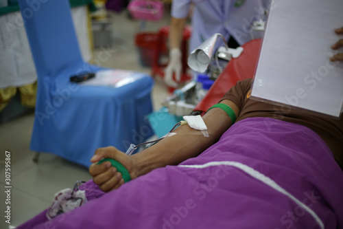 Blood donor at donation with a bouncy ball holding in hand, image for Thai Nov 2019