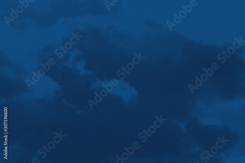 Thunderclouds on blue sky background.