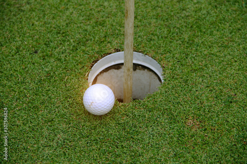 golf ball on green in the evening golf course with sunshine.