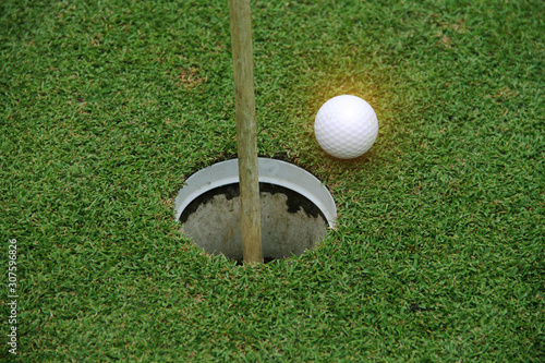 golf ball on green in the evening golf course with sunshine.