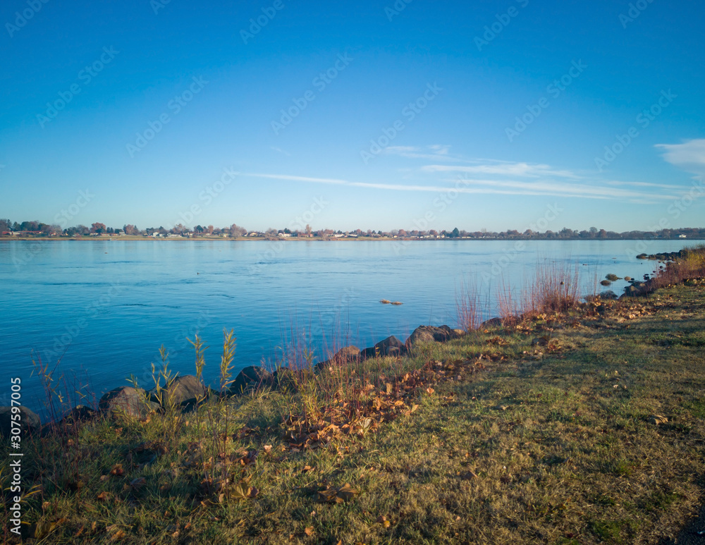 Paddling ducks in the Columbia River with blue skies and clouds on a sunny morning in Kennewick-Pasco Washington Paddling ducks in the Columbia River with blue skies and clouds on a sunny morning in Kennewick-Pasco Washington