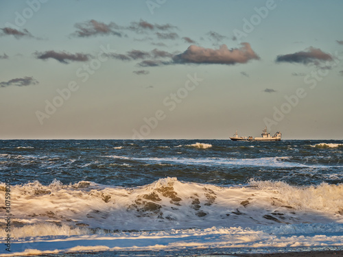 Stormy beach in Thyboroen, West Denmark photo