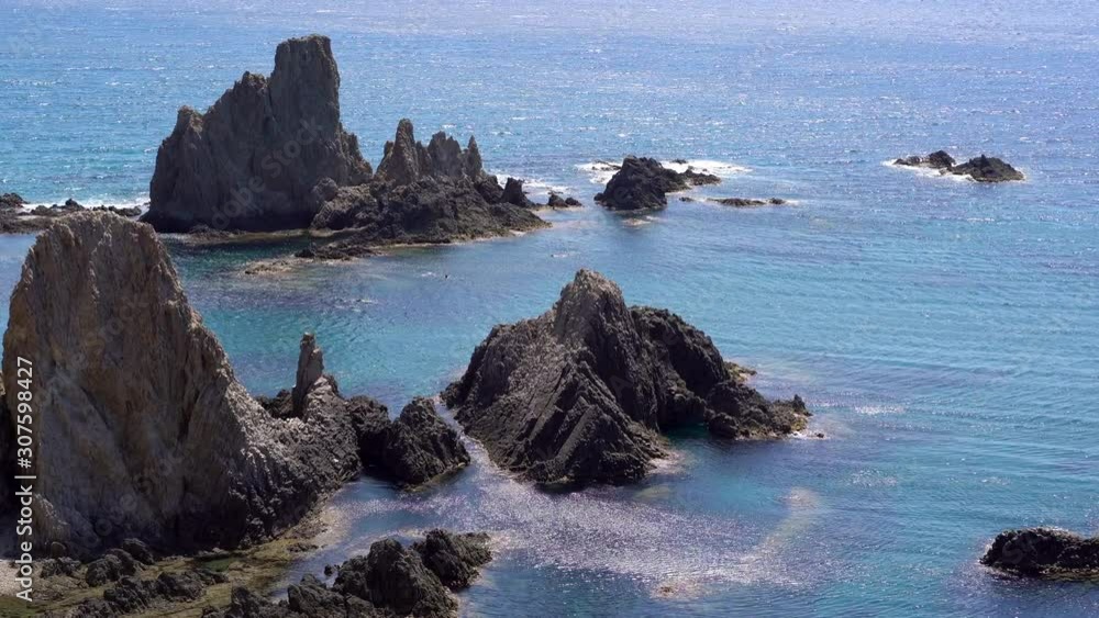 People bathing at Las Sirenas bay, Cabo De Gata, Almeria. Zoom in People bathing at Las Sirenas bay, Cabo De Gata, Almeria. Zoom in