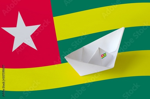 Togo flag depicted on paper origami ship closeup. Handmade arts concept photo