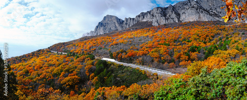 Beautiful autumn landscape with a road and mountains © fotomaster