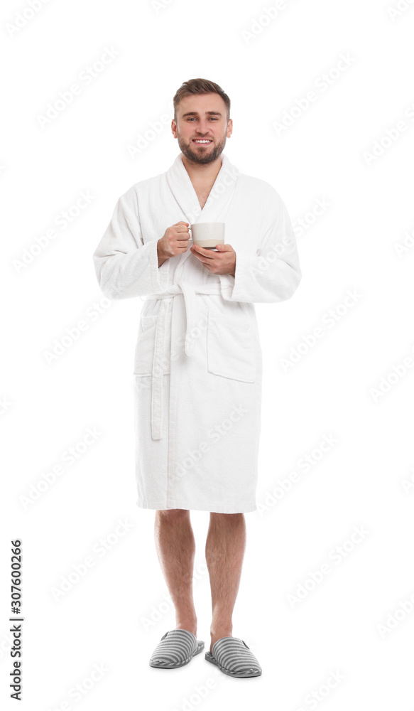 Handsome man with cup of coffee wearing bathrobe on white background Handsome man with cup of coffee wearing bathrobe on white background