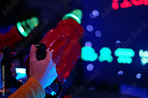 Close up of one hands playing in a game machine in an Arcade entertainment center.