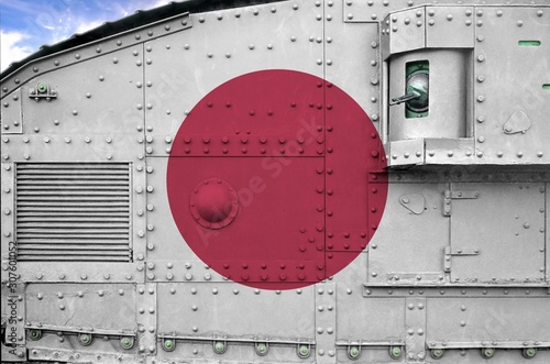 Japan flag depicted on side part of military armored tank closeup. Army forces conceptual background photo