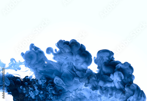 Colorful cloud of blue underwater paint on white background.