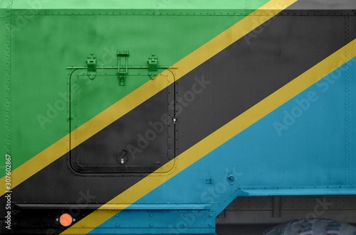 Tanzania flag depicted on side part of military armored truck closeup. Army forces conceptual background photo