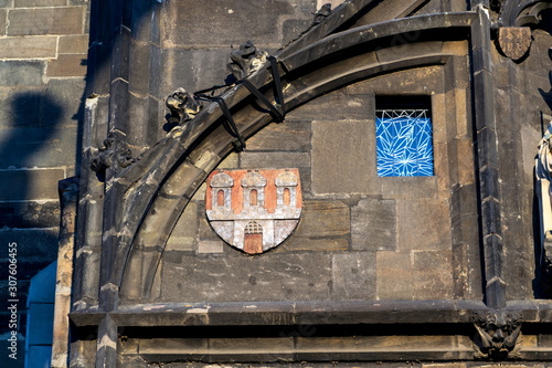 Coat of arms on the Old Town Bridge Tower guarding end of the Charles Bridge and entrance to Old Town of Prague, Czech Republic, sunny summer morning