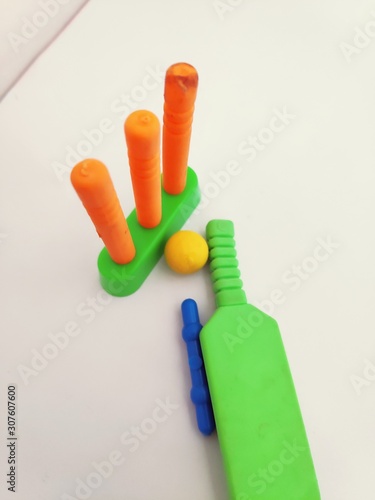 Colorful cricket equipment bat ball and wicket isolated on white background