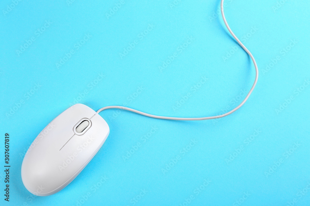 Modern wired mouse on light blue background, top view Modern wired mouse on light blue background, top view