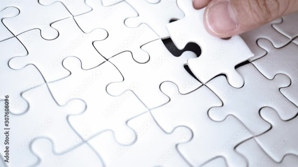 last piece of jigsaw filling by hand, step of success concept last piece of jigsaw filling by hand, step of success concept