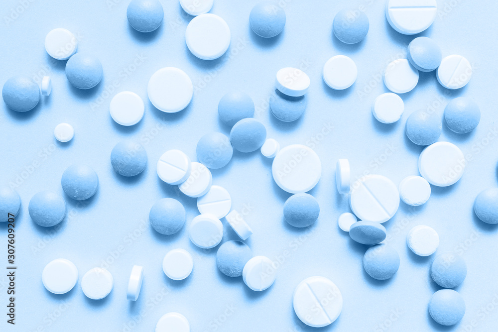 Classic blue colorful chocolate candies isolated on neo mint background. Heap of candies multi colored against a neo mint texture. Top view or flat lay. Color of the year 2020. Main trend Classic blue colorful chocolate candies isolated on neo mint background. Heap of candies multi colored against a neo mint texture. Top view or flat lay. Color of the year 2020. Main trend