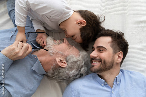 Tablou pe pânză Above close up view laughing three generations of men family