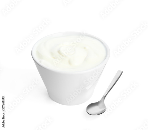 Tasty organic yogurt in bowl and spoon isolated on white