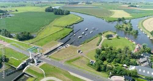 Stationairy Shot of Recreational Boats Exiting the “Dokkumer Nieuwe Zijlen” Sluice, Friesland, Netherlands / Holland – 4K Drone Footage photo