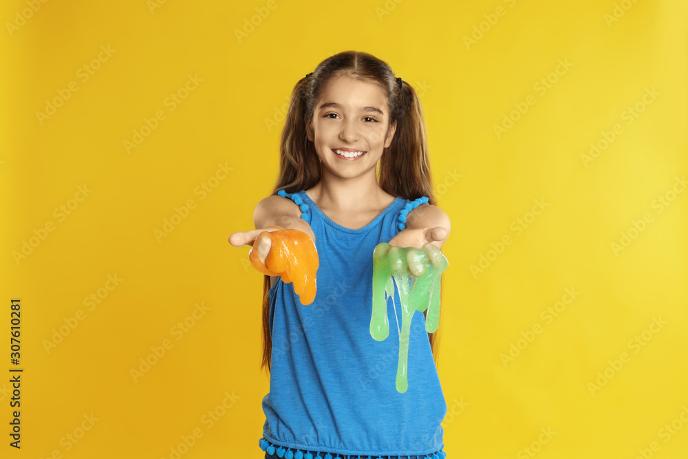 Preteen girl with slime on yellow background Preteen girl with slime on yellow background
