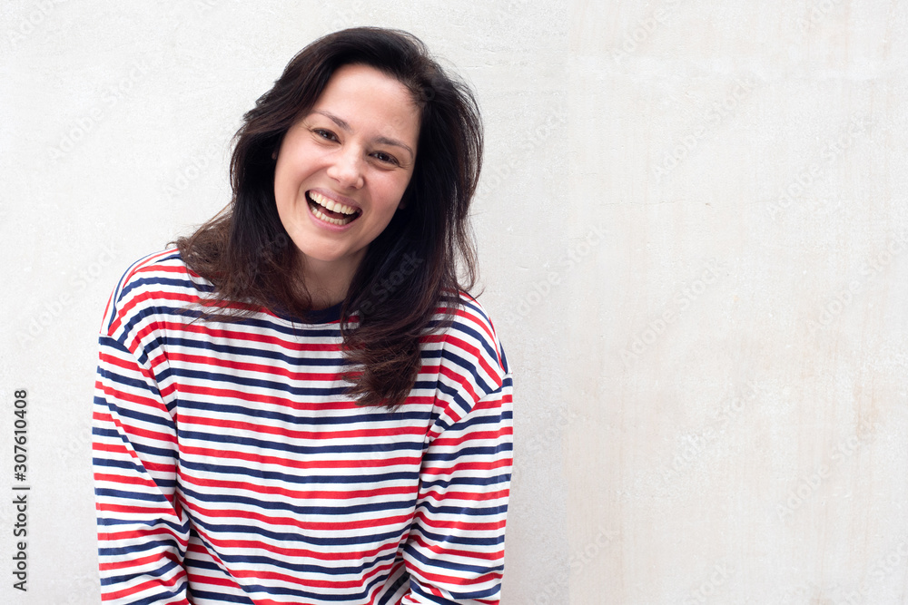 young woman smiling by white background